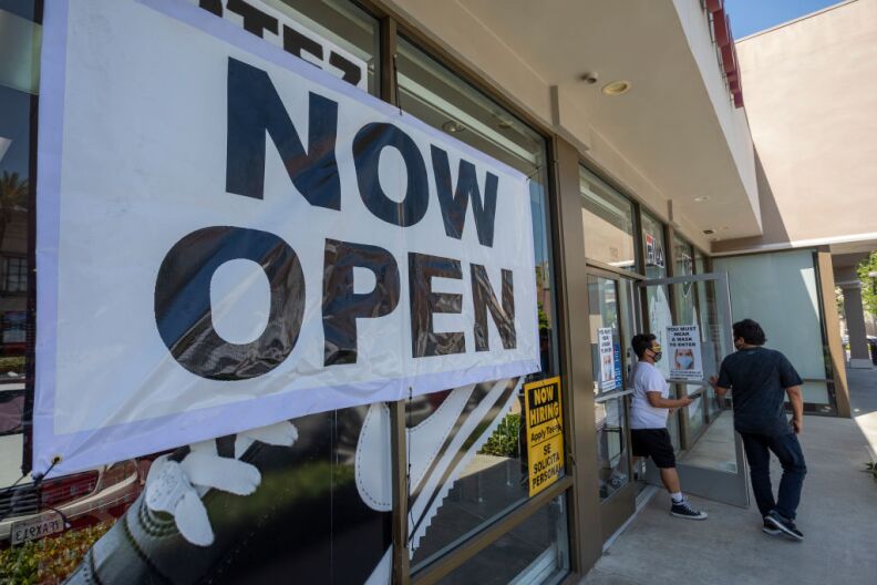 GLENDALE, CA - MAY 27: People exit a Shoe City store as Los Angeles County retail businesses reopen while the COVID-19 pandemic continues on May 27, 2020 in Glendale, Californias latest guidelines and allow the resumption of in-store shopping at low-risk retail stores, faith-based services, drive-in theaters and other recreational activities with reduced capacities and social distancing restrictions, starting today. Not reopening yet are personal services locations like hair salons and dining in at restaurants.  (Photo by David McNew/Getty Images)