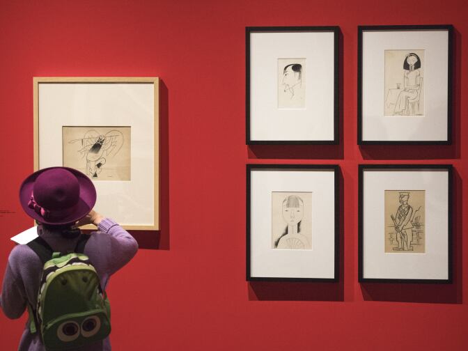 Freelance writer Jana Monji looks at the work from artist Miguel Covarrubias, part of the "Winds from Fusang: Mexico and China in the Twentieth Century" exhibit during a media tour of the newly renovated USC Pacific Asia Museum, December 6, 2017.  (Photo/Gus Ruelas)