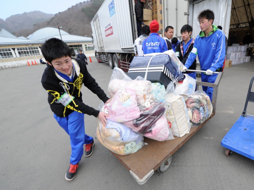 Volunteers push a trolley filled with blankets destined for displaced people in the city of Kamaishi in Iwate prefecture.