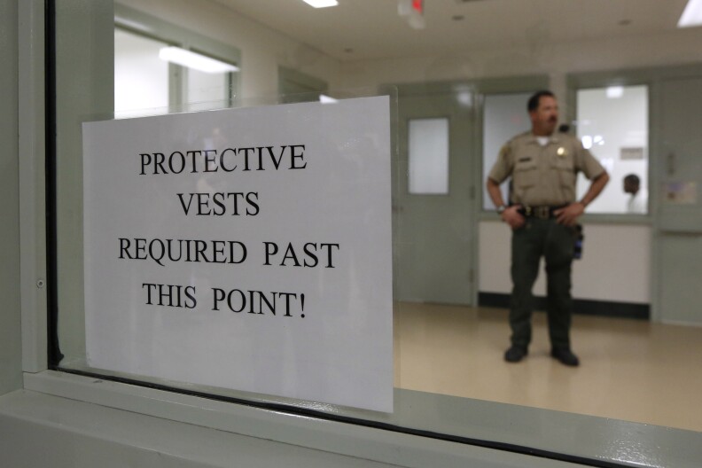 A sign warns care givers and correctional officers that protective vests are required in one of the treatment areas at the newly opened mental health treatment unit at the California Medical Facility in Vacaville, Calif., Thursday, Feb. 14, 2013.  The  $24 million treatment center for mentally ill inmates opened on Thursday as state corrections officials used the occasion to push for ending federal oversight of that aspect of prison operations. The 44,000-square-foot building includes rooms where inmates will undergo individual, group and recreational outpatient therapy. It will be used to treat inmates who are seriously mentally ill but are able to function without around-the-clock care.