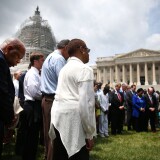 WASHINGTON, DC - JUNE 18: Rep. John Lewis (D-GA) (L) joins members of the US House of Representatives and members of the US Senate in a prayer circle in front of the US Capitol to honor those gunned down last night inside the historic Emanuel African Methodist Episcopal Church in Charleston South Carolina, June 18, 2015 in Washington, DC. Police have arrested Dylann Roof, 21, of Lexington, South Carolina in the shooting that killed 9 people. (Photo by Mark Wilson/Getty Images)