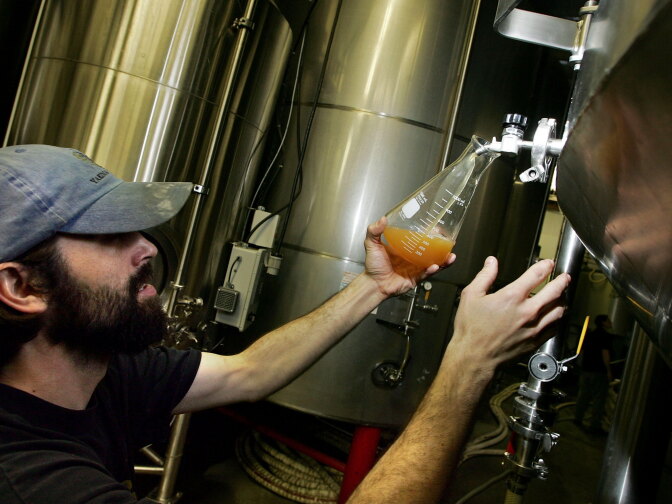 PETALUMA, CA - MARCH 28:  Lagunitas Brewing Company brewer Tim Goeppinger takes a sample of beer from a tank at the brewery March 28, 2006 in Petaluma, California. Production of craft and micro-brewed beer grew by 9 percent last year, the biggest jump since 1996, while mainstream beer sales fell as beer drinkers seek a better and more unique tasting beer.  (Photo by Justin Sullivan/Getty Images)