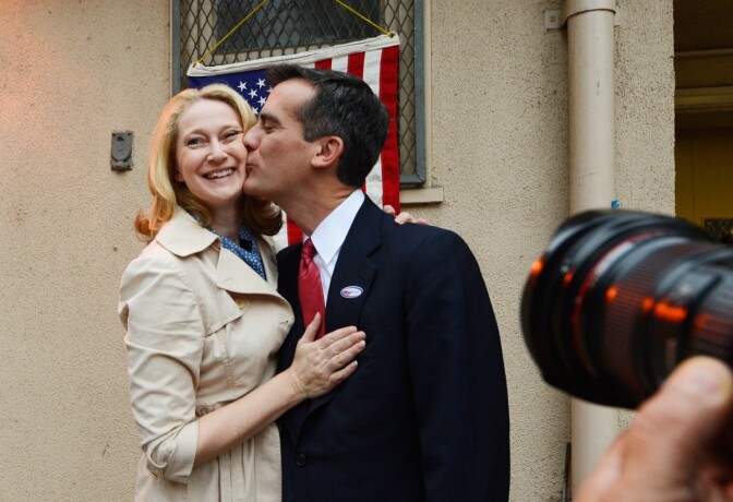 Candidate in the Los Angeles City mayoral race, Councilman Eric Garcetti kisses his wife Amy Wakeland after they voted at Allesandro Elementary School on March 5, 2013 in the Boyle Heights area of Los Angeles.