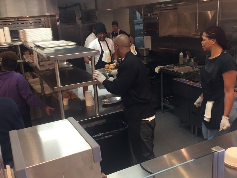 Line workers in the kitchen of LocoL are preparing for opening day. LocoL is a new fast food restaurant created by chef Roy Choi in the Watts neighborhood of LA.