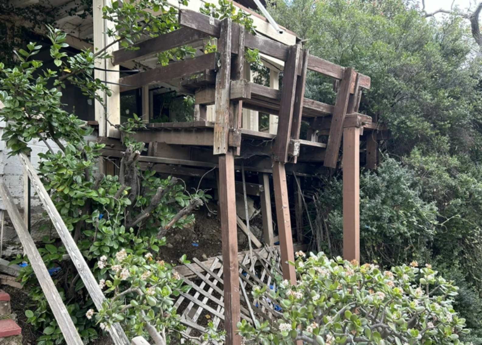 A wooden deck that seems like it's going to collapse.