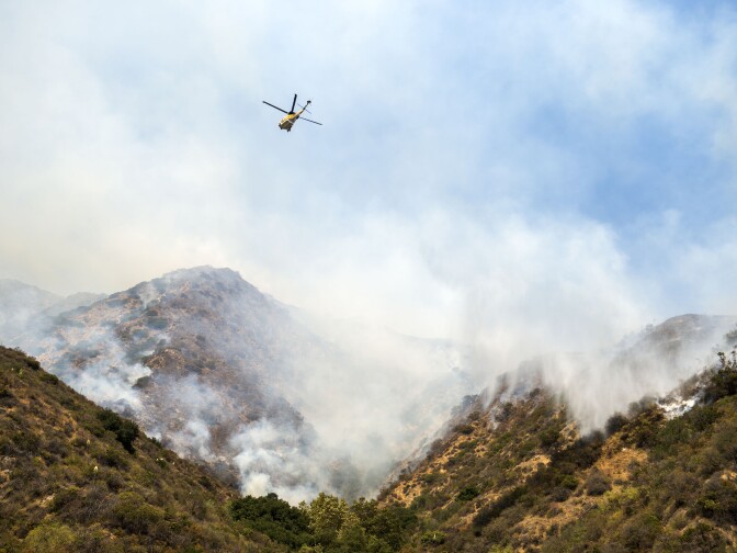A firefighting helicopter flies over the Brand Fire Sunday afternoon. 


The Brand Fire burns near Glendale and Burbank on Sunday, June 22nd, 2014. No evacuations were in place and the blaze had burned an estimated 75 acres by 6 p.m.