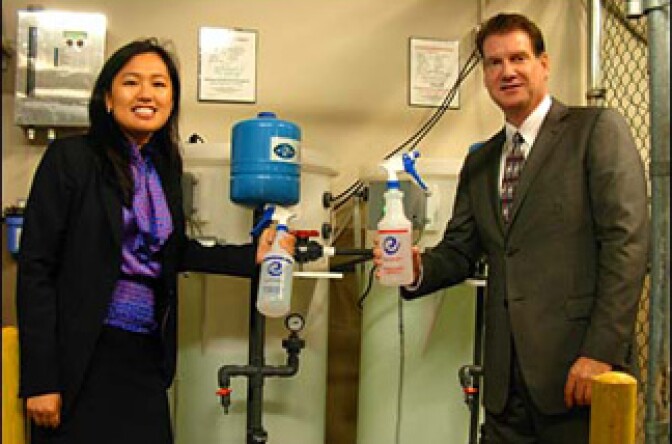 Glenn Epstein and Zie Zie Senzaki of the Sheraton Delfina in Santa Monica, next to the Electrolyzer machine that makes most of their cleaning product.