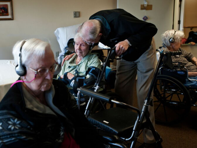 Frank M. greets his wife, Delores, in the recreation room. Now, there are more than 60 facilities throughout the U.S. and Canada that are part of the Music & Memory program.