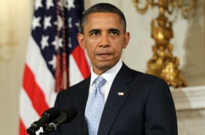 President Barack Obama pauses as he makes a statement at the State Dining Room of the White House.