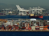 Ships wait to be loaded at the Port of Los Angeles in Long Beach on February 13, 2015.  US West Coast ports have partially closed due to a dispute between staff and bosses along the key trade frontline with Asia. The Pacific Maritime Association, which represents employers, announced the suspension of loading and unloading of ships at 29 West Coast ports.        AFP PHOTO/Mark RALSTON        (Photo credit should read MARK RALSTON/AFP/Getty Images)