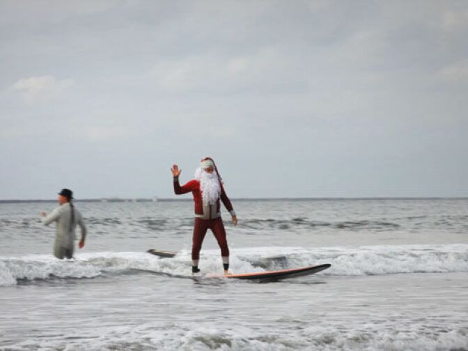 Surfing Santa and his entourage bring the Christmas spirit to Seal Beach.