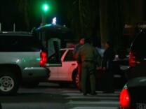 A man opened fire on a police car in South Los Angeles Sunday night, but no one was hurt. The suspect was eventually arrested, and police searched for a second suspect without success.