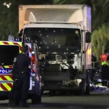 Police officers stand near a truck, with its windscreen riddled with bullets, that ploughed into a crowd leaving a fireworks display in the French Riviera town of Nice on July 14, 2016.
At least 60 people were killed when a truck ploughed into a crowd watching a Bastille Day fireworks display in the southern French resort of Nice, prosecutors said early on July 15. Nice prosecutor Jean-Michel Pretre said the truck drove two kilometres (1.3 miles) through a large crowd that was watching the fireworks.
 / AFP / VALERY HACHE        (Photo credit should read VALERY HACHE/AFP/Getty Images)