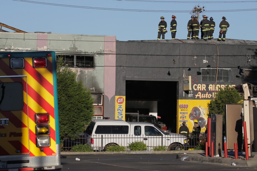 OAKLAND, CA - DECEMBER 03:  Firefighters investigate the scene of a overnight fire that claimed the lives of at least nine people at a warehouse in the Fruitvale neighborhood on December 3, 2016 in Oakland, California. The warehouse was hosting an electronic music party.  (Photo by Elijah Nouvelage/Getty Images)