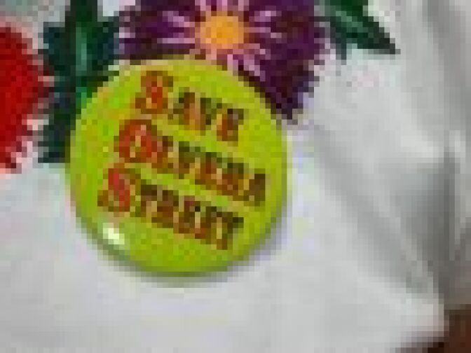 A merchant sports a badge saying "Save Olvera Street" at the 80th anniversary celebrations of Olvera Street near downtown Los Angeles on April 24, 2010.