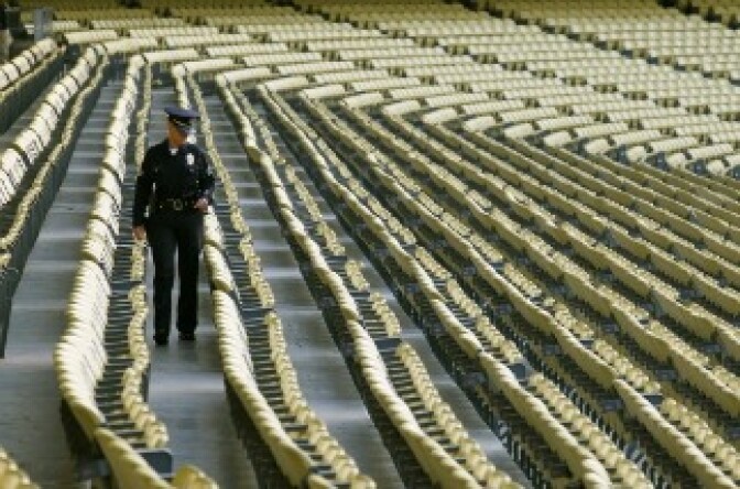 A police officers walks in the seats before the game between the San Francisco Giants and the Los Angeles Dodgers on May 18, 2011 at Dodger Stadium in Los Angeles, California.