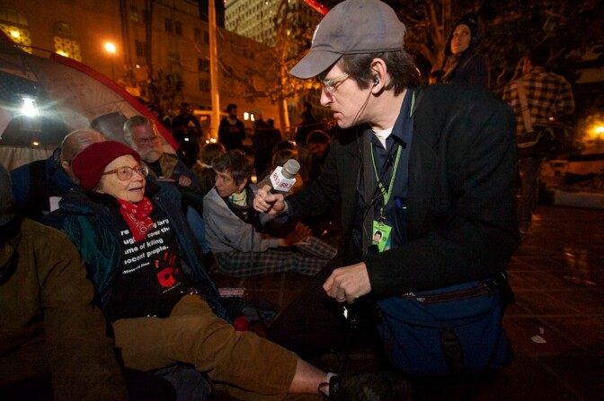Off-Ramp host John Rabe with 79-year old OccupyLA protestor Dorothy "Ruth" Sarnoff. According to a database on the LA Times website, she was the oldest person arrested in the LAPD raid by ten years.