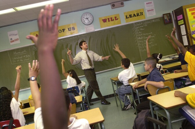 Teacher David Nieder of 'Knowledge is Power Program' (KIPP) Academy takes questions from his class October 4, 2000 in The Bronx, New York. The Knowledge Is Power Program educates 200 middle-school students, mostly poor black and Latino neighborhood children, housed in a hallway on the fourth floor of a regular Bronx public schooI. Because of strict discipline where each student gets two hours of homework a night and a regular school day runs nine-and-a-half-hours, including Saturdays and throughout the summer, test scores are the highest in the Bronx. Governor George Bush of Texas, where another KIPP school is run, singled out KIPP for praise during his presidential debate against Vice President Al Gore.