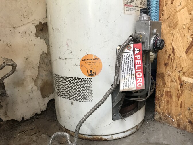 An apartment water heater is tagged as dangerous.