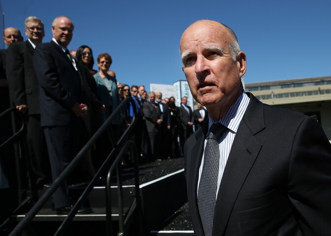 SAN FRANCISCO, CA - SEPTEMBER 16:  California Gov. Jerry Brown walks on stage before speaking during the Drive The Dream event at the Exploratorium on September 16, 2013 in San Francisco, California. California Gov. Jerry Brown met with California corporate leaders at Drive The Dream to discuss progress in the adoption of electric vehicles and workplace charging stations at businesses in the state.  (Photo by Justin Sullivan/Getty Images)