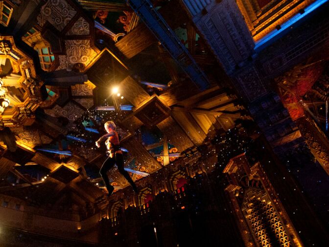 In one scene, Cathy Rigby flies over the audience, approximately 12 rows back. At 15 years old, Rigby was the first-ever American female to medal in the World Gymnastics competition.