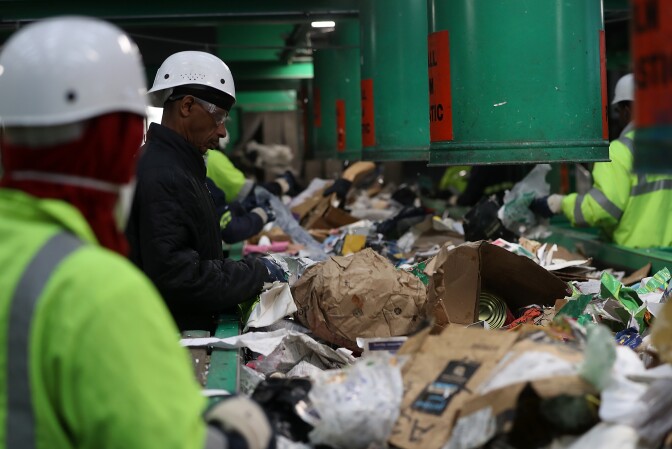 SAN FRANCISCO, CA - JANUARY 04:  Workers sort through cardboard and mixed paper at Recology's Recylce Central on January 4, 2018 in San Francisco, California. Recycle centers are seeing a spike in cardboard recycling following the holidays after a record year for online retailers. The U.S. Postal Service estimates that they delivered ten percent more packages in 2017 with Amazon shipping over five billion items for Prime members.  (Photo by Justin Sullivan/Getty Images)