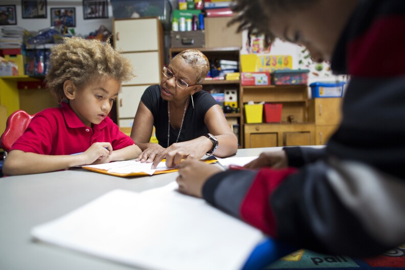 Tonia McMillian helps 7-year-old Jayden with his homework after school on Feb. 12.