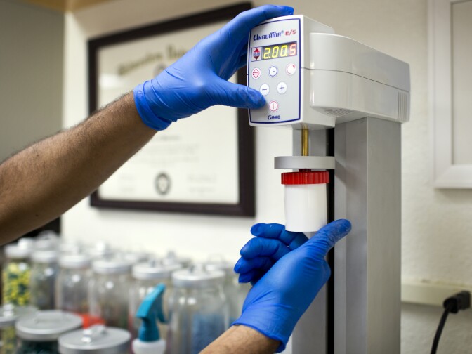 The compound cream is mixed even more using an electronic mortar and pestle.