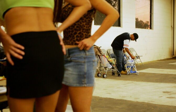 POMONA, CA - NOVEMBER 12:  A man folds up baby strollers that were taken from his confiscated car after his arrest by a female police officer posing as a prostitute on Holt Boulevard, known to sex workers throughout southern California as "the track", during a major prostitution sting operation November 12, 2004 in Pomona, California.  Approximately 60 to 80 men are arrested each night during the sting operations. Cars driven by the arrested men are seized and become city property until a $1000 fine is paid. Each vehicle is then labeled with a large window sticker stating that the car was ?seized for solicitation of prostitution? and the photos of the men appear in a full-page ad in the local newspaper.  (Photo by David McNew/Getty Images)