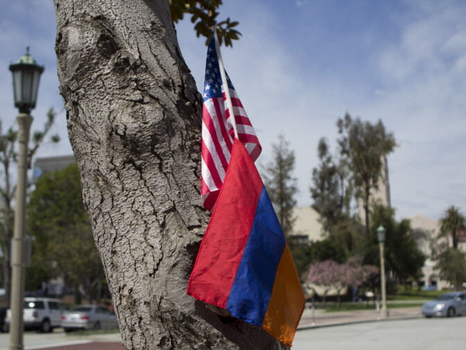 An American and Armenian flag rest together against a tree. Many of the speeches focused on the role of Armenia and America together in increasing recognition of the genocide.