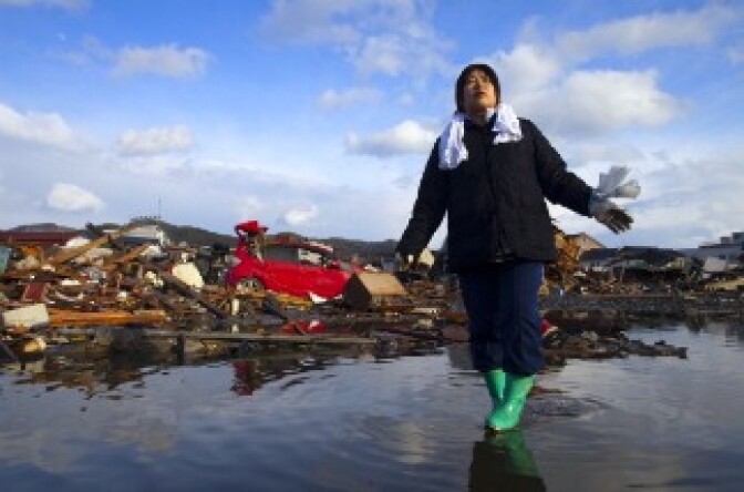 Chieko Chiba walks through the rubble after going to see her destroyed home March 16, 2011 in Kesennuma, Miyagi province, Japan.