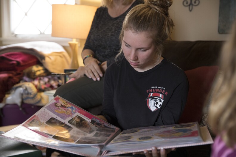 Amber Patterson looks at family photo albums at home in Lomita, Calif. on Oct. 30, 2017. Lisa Patterson was killed during the Oct. 1 attack in Las Vegas.