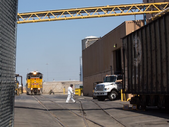 An employee wearing a breathing mask works at Exide Technologies, a battery recycling plant has discharged harmful amounts of lead into surrounding communities.