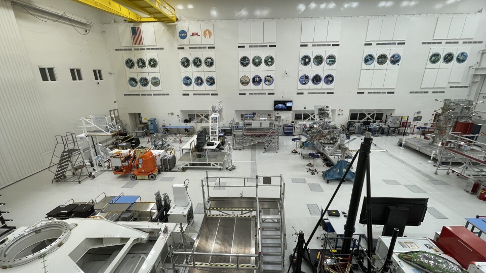 A giant white room with robotic parts in it.