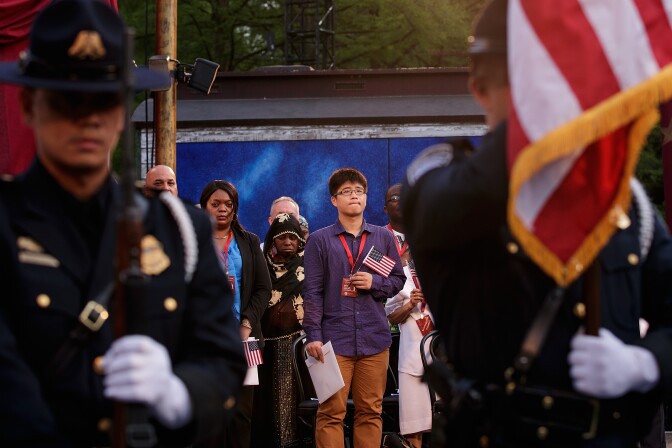 NEW YORK, NY - JUNE 20: Immigrants wait to take the oath of citizenship during a naturalization ceremony in at the Delacorte Theater in Central Park, June 20, 2016 in New York City. Started by the United Nations in 2000, June 20 is World Refugee Day. (Photo by Drew Angerer/Getty Images)