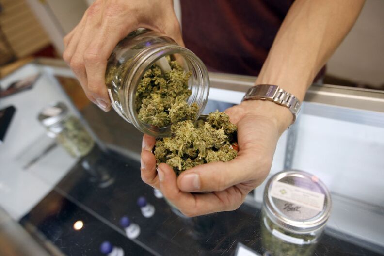 A budtender pours marijuana from a jar at Perennial Holistic Wellness Center medical marijuana dispensary, which opened in 2006, on July 25, 2012 in Los Angeles.
