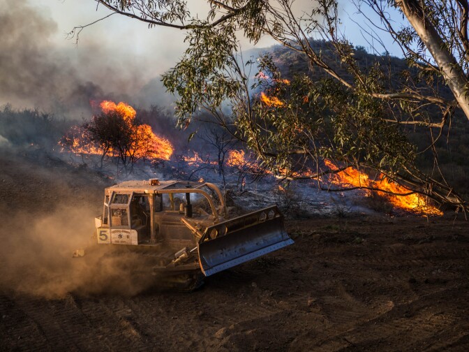 A bulldozer clears fire lines near homes in the unincorporated Newbury Park neighborhood west of Thousand Oaks in Ventura County on May 2, 2013.
