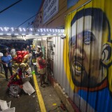 BATON ROUGE, LA -JULY 06:  protesters gather in front of a mural painted on the wall of the convenience store where Alton Sterling was shot and killed, July 6, 2016 in Baton Rouge, Louisiana.  Sterling was shot by a police officer in front of the Triple S Food Mart in Baton Rouge on Tuesday, July 5, leading the Department of Justice to open a civil rights investigation. (Photo by Mark Wallheiser/Getty Images)
