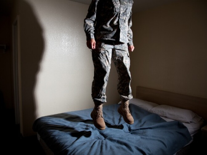 Grace is photographed jumping on a bed for Jeff Sheng's "Don't Ask, Don't Tell" exhibit.