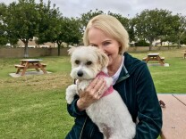 Jan Curtis and her dog, Belle, at a park near her Huntington Beach home on April 27, 2018. Curtis hopes she's nearing the end of a decades-long struggle with chronic pain and the opioid dependence that came with it. 