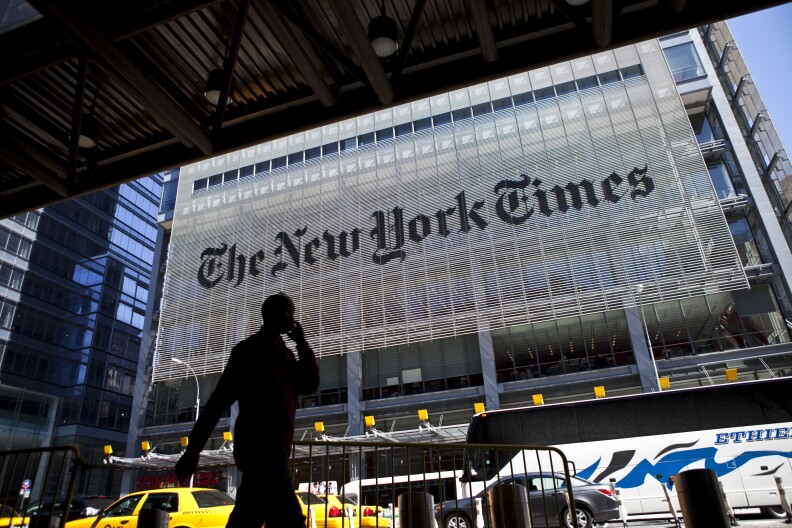NEW YORK - APRIL 21: A man speaks on his mobile phone across from The New York Times headquarters building April 21, 2011 in New York City. The New York Times profits fell 58 percent in the first quarter of 2011. (Photo by Ramin Talaie/Getty Images)