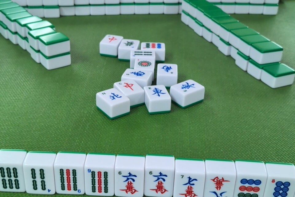A table of tiles with Chinese words and patterns on them.