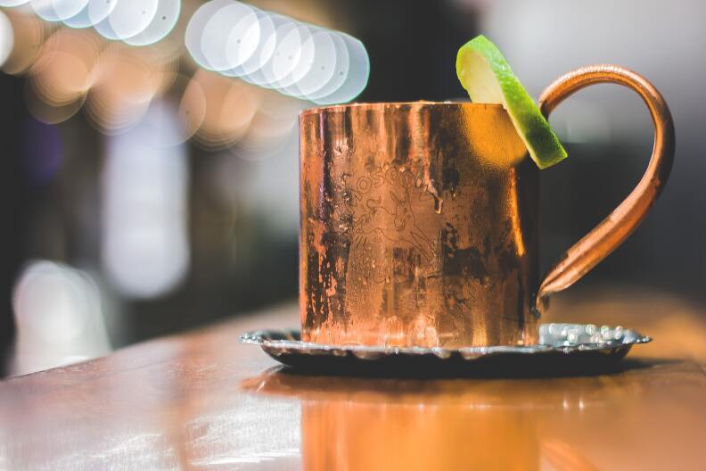Moscow Mule in the classic copper cup with handle and a lime slice