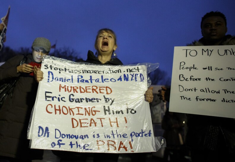 NEW YORK, NY - DECEMBER 3: A woman holds a banner as she takes part during a protest in support of Eric Garner at Union Square on December 3, 2014 in New York City. Garner died after being put in a chokehold during an alteration with NYPD officers in the Staten Island borough of New York City.  (Photo by Kena Betancur/Getty Images)