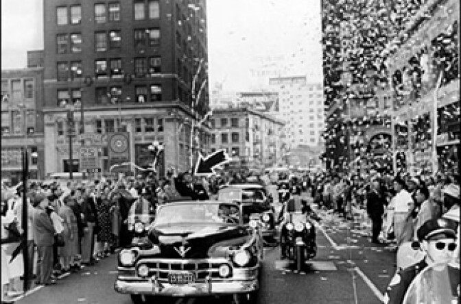 A waving Stevenson in the Los Angeles ticker tape parade at Eighth and Spring streets.