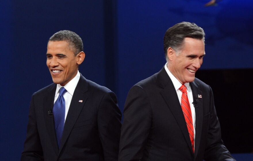 US President Barack Obama (L) and Republican presidential candidate Mitt Romney finish their debate at the University of Denver in Denver, Colorado, October 3, 2012. After hundreds of campaign stops, $500 million in mostly negative ads and countless tit-for-tat attacks, Obama and Romney go head-to-head in their debut debate.