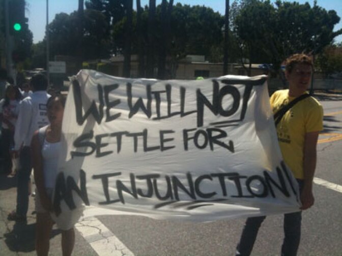 Gabriel Strachota and Laura Lopez hold a sign protesting the Arizona immigration law.