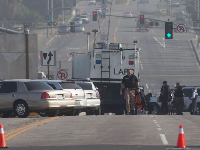 An LAPD officer walks on an I-15 overpass in Corona where police say Christopher Dorner shot at two officers. Police across the state are searching for Christopher Dorner in connection with a string of homicides.