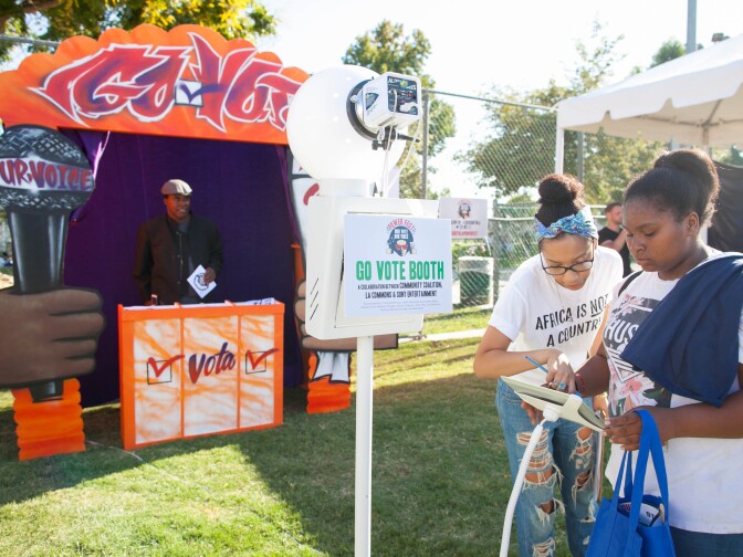 Local residents learn about the history of African-American voting in the U.S., review issues that will be on the ballot, and register to vote during the 5th annual Power Fest Music and Art Festival in Martin Luther King Jr. Park on Saturday, Sept. 3, 2016.