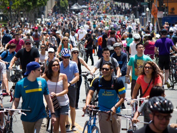 Cyclists and pedestrians climb Wilshire Boulevard in downtown L.A. during the seventh CicLAvia event on June 23, 2013.